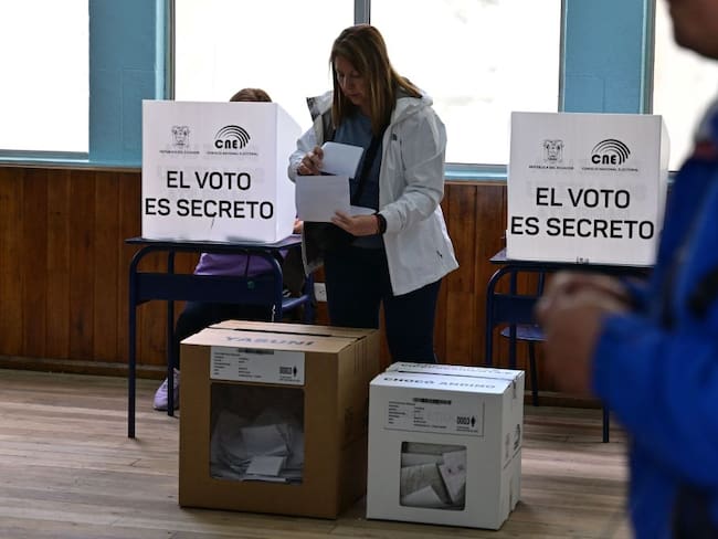 A woman votes at a polling station in Quito during the Ecuadorean presidential election and referendum on mining and petroleum, on August 20, 2023. Ecuador holds a presidential election after a campaign marked by the murder of a top candidate and vows to tackle the lawlessness that has engulfed the once-peaceful nation. Alongside the presidential vote, two key referendums are taking place in one of the world's most biodiverse countries. (Photo by MARTIN BERNETTI / AFP) (Photo by MARTIN BERNETTI/AFP via Getty Images)