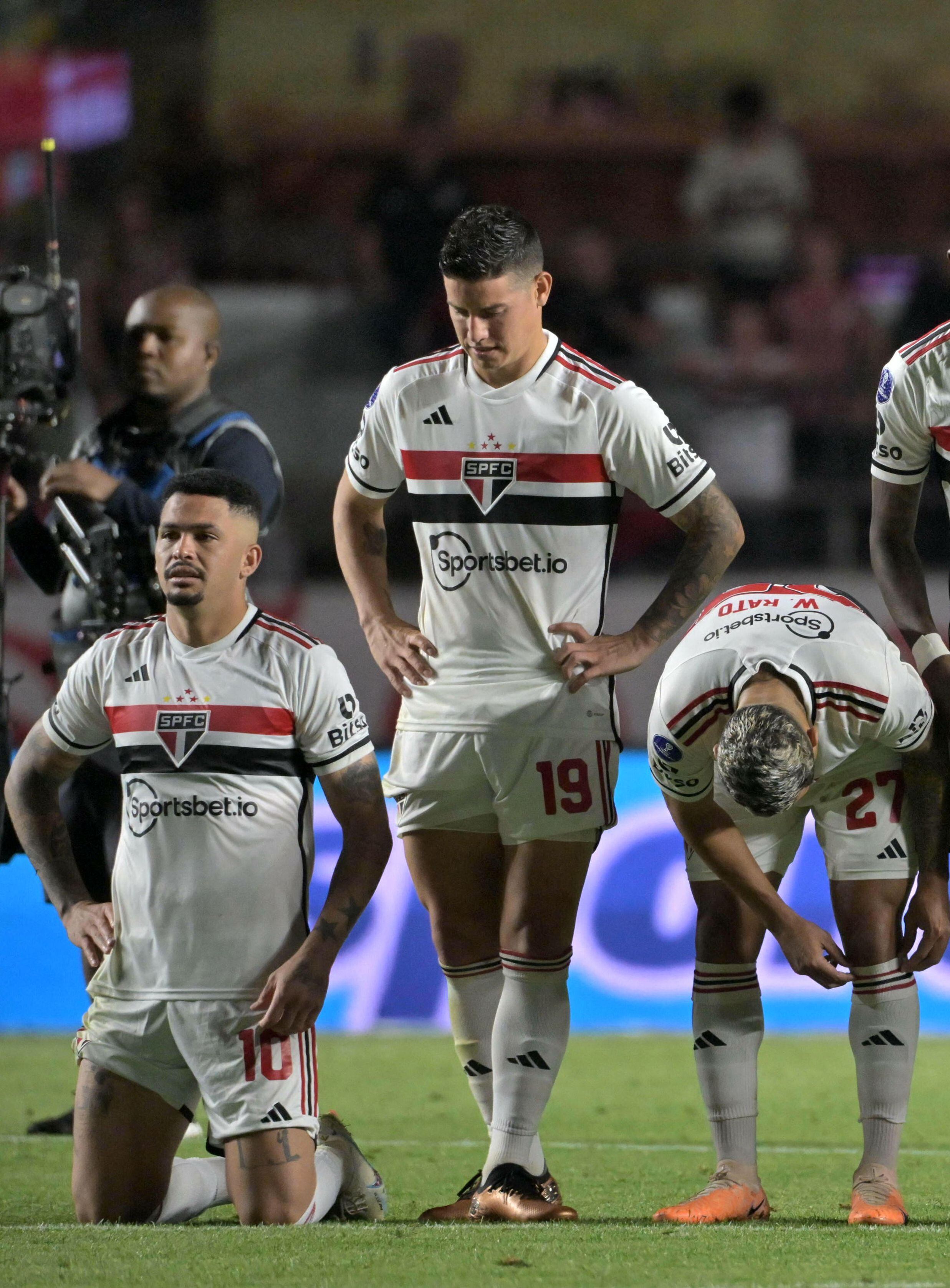 Sao Paulo's forward Luciano (L), Colombian midfielder James Rodriguez (C), and midfielder Wellington Rato react after losing against Liga de Quito in the penalty shoot-out of the Copa Sudamericana quarterfinals second leg football match between Brazil's Sao Paulo and Ecuador's Liga de Quito at the Morumbi stadiumn, in Sao Paulo, Brazil, on August 31, 2023. (Photo by NELSON ALMEIDA / AFP) (Photo by NELSON ALMEIDA/AFP via Getty Images)