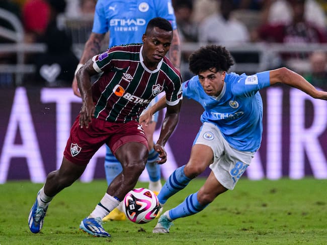 JEDDAH, SAUDI ARABIA - DECEMBER 22: Jhon Arias of Fluminense (L) dribbles Rico Lewis of Manchester City (R) during the FIFA Club World Cup Final match between Manchester City and Fluminense at King Abdullah Sports City on December 22, 2023 in Jeddah, Saudi Arabia. (Photo by Marcio Machado/Eurasia Sport Images/Getty Images)