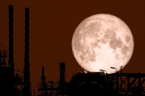 Full Strawberry Moon back on silhouette refinery on night sky, Elements of this image furnished by NASA