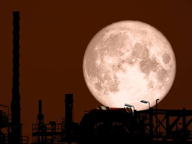 Full Strawberry Moon back on silhouette refinery on night sky, Elements of this image furnished by NASA