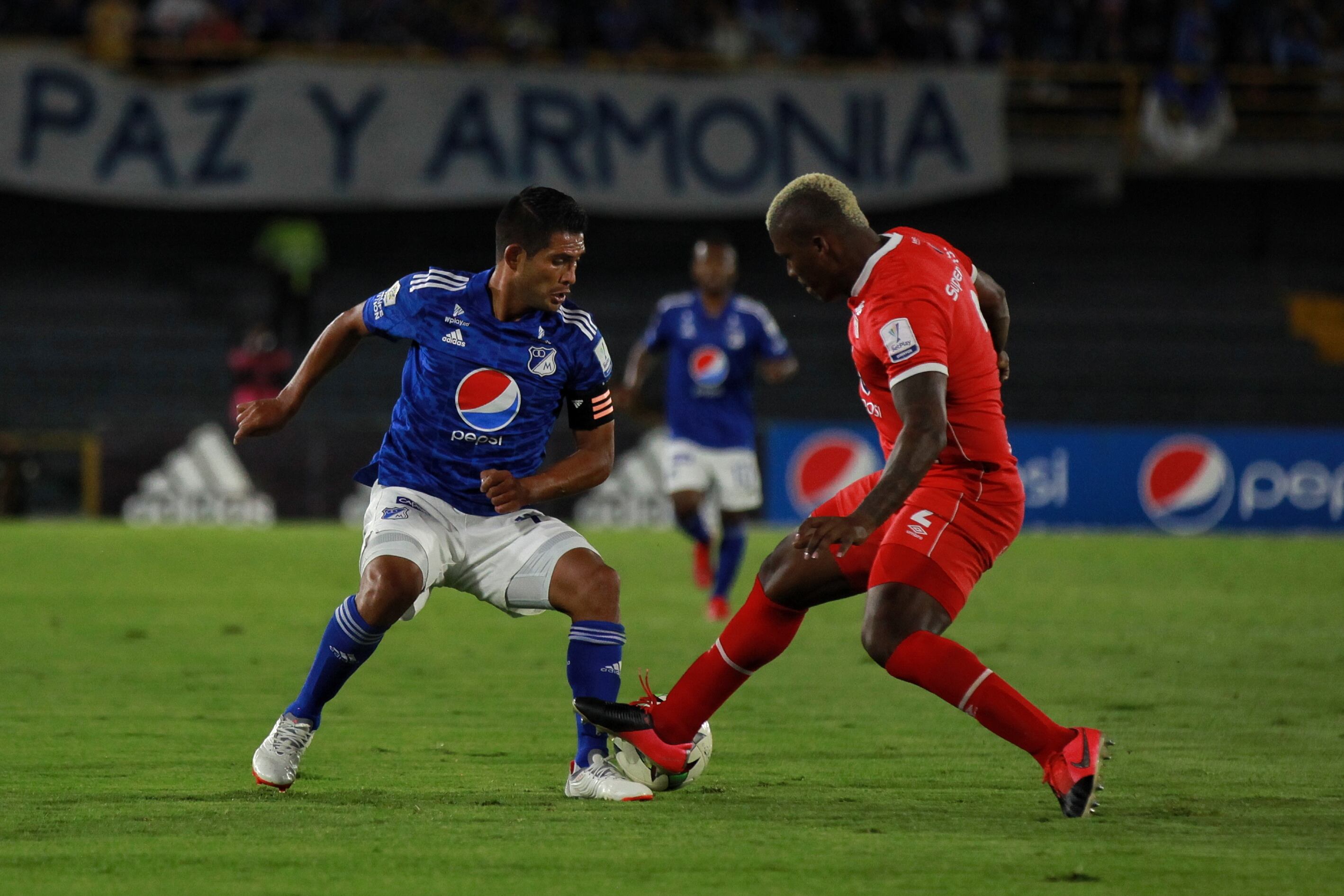 David Mackalister Silva, capitán de Millonarios, ante la marca de Marlon Torres, defensa del América / Colprensa.