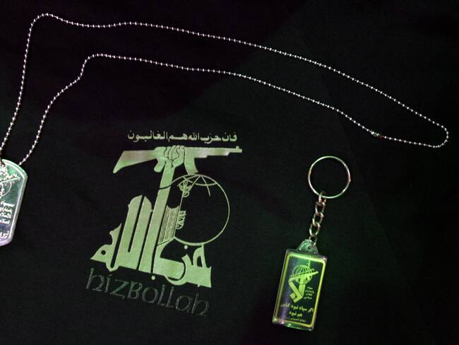 A dog tag (L) and a key ring (R) are seen on a T-shirt with the logotype of the Lebanese radical Islamic Shiite organization Hezbollah 28 July 2006 at an military supply shop, in Sao Paulo, Brazil. According to its owner the demand for Hezbollah T-shirts has increased after the beginning of Israeli military offensive on Lebanon AFP PHOTO/Mauricio LIMA (Photo by MAURICIO LIMA / AFP) (Photo by MAURICIO LIMA/AFP via Getty Images)