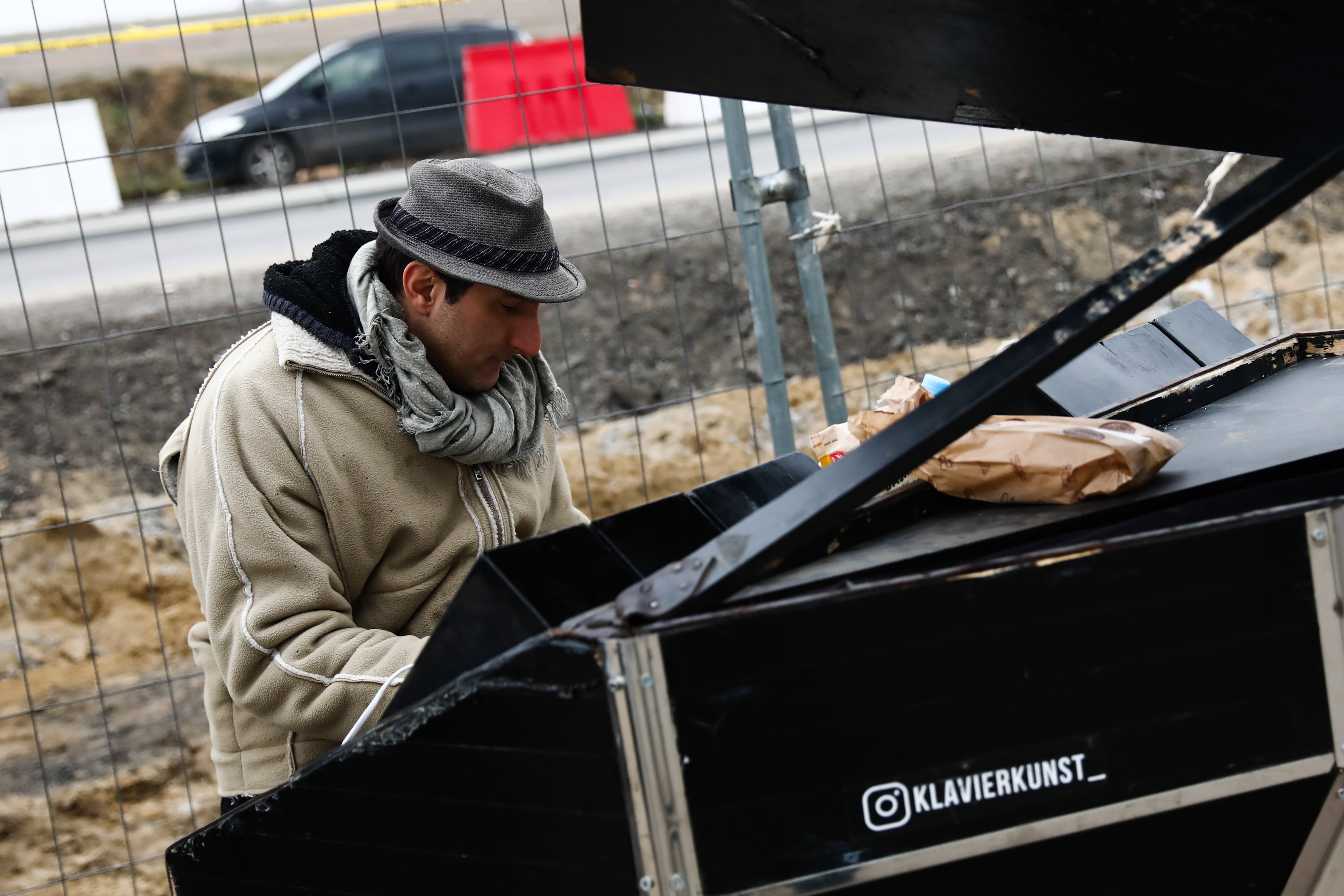 Davide Martello plays a piano near the Ukrainian border in Medyka, Poland on March 4, 2022. Thousands of refugees cross the Ukrainian-Polish border due to the Russian invasion of Ukraine. (Photo by Jakub Porzycki/NurPhoto via Getty Images)