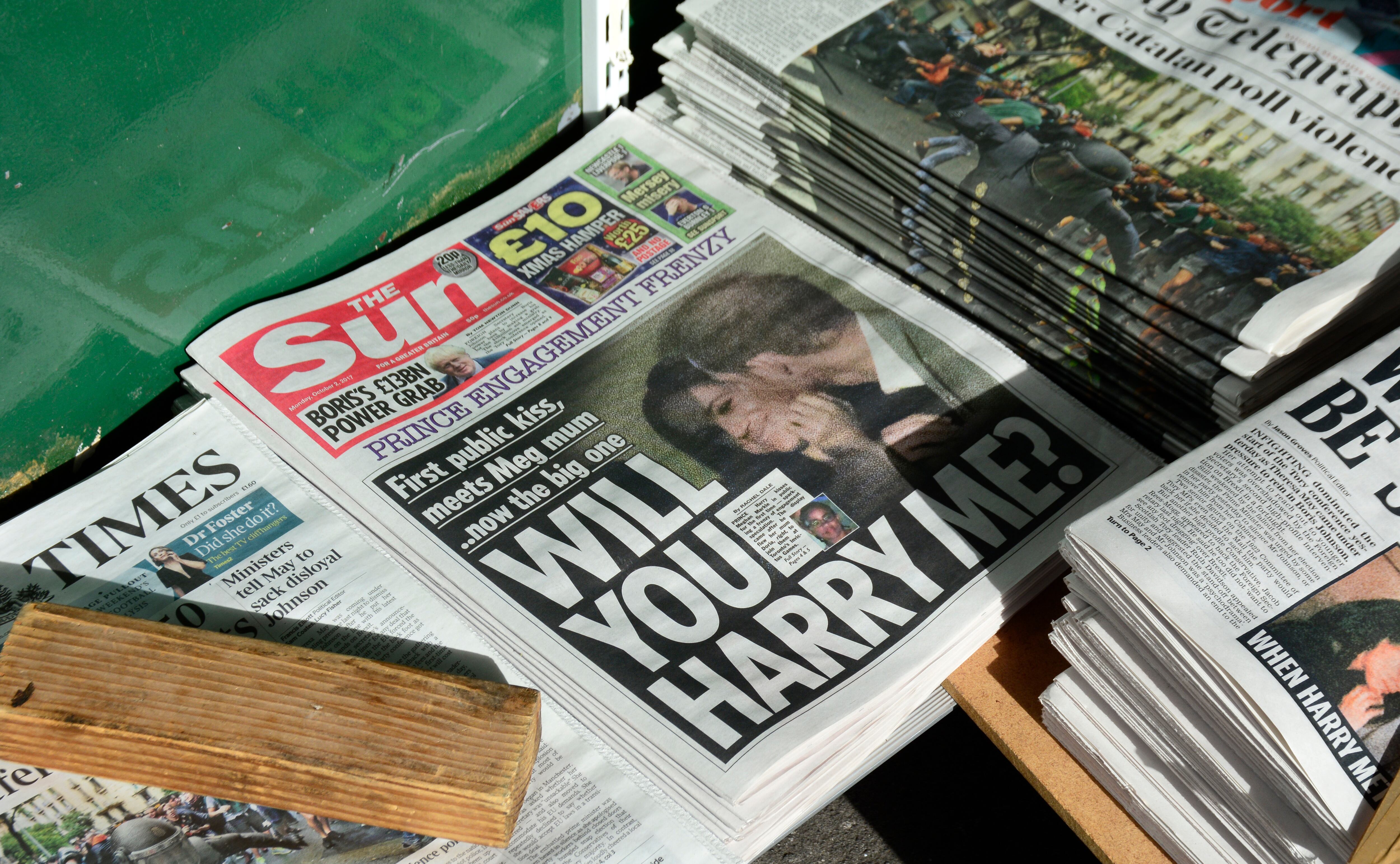LONDON, ENGLAND - OCTOBER 2, 2017:  A variety of daily newspapers, including The Sun, for sale at a newstand in London, England. The Sun's headline refers to Prince Harry and his girlfriend, Meghan Markle. (Photo by Robert Alexander/Getty Images)