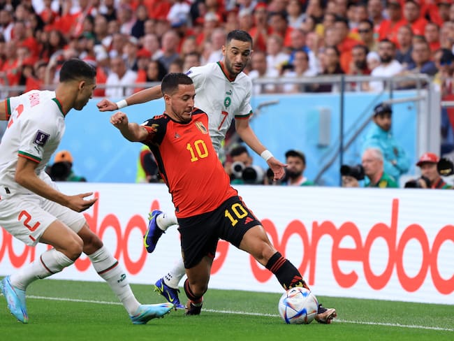 DOHA, QATAR - NOVEMBER 27: Eden Hazard of Belgium controls the ball against Achraf Hakimi (L) and Hakim Ziyech of Morocco  during the FIFA World Cup Qatar 2022 Group F match between Belgium and Morocco at Al Thumama Stadium on November 27, 2022 in Doha, Qatar. (Photo by Buda Mendes/Getty Images)