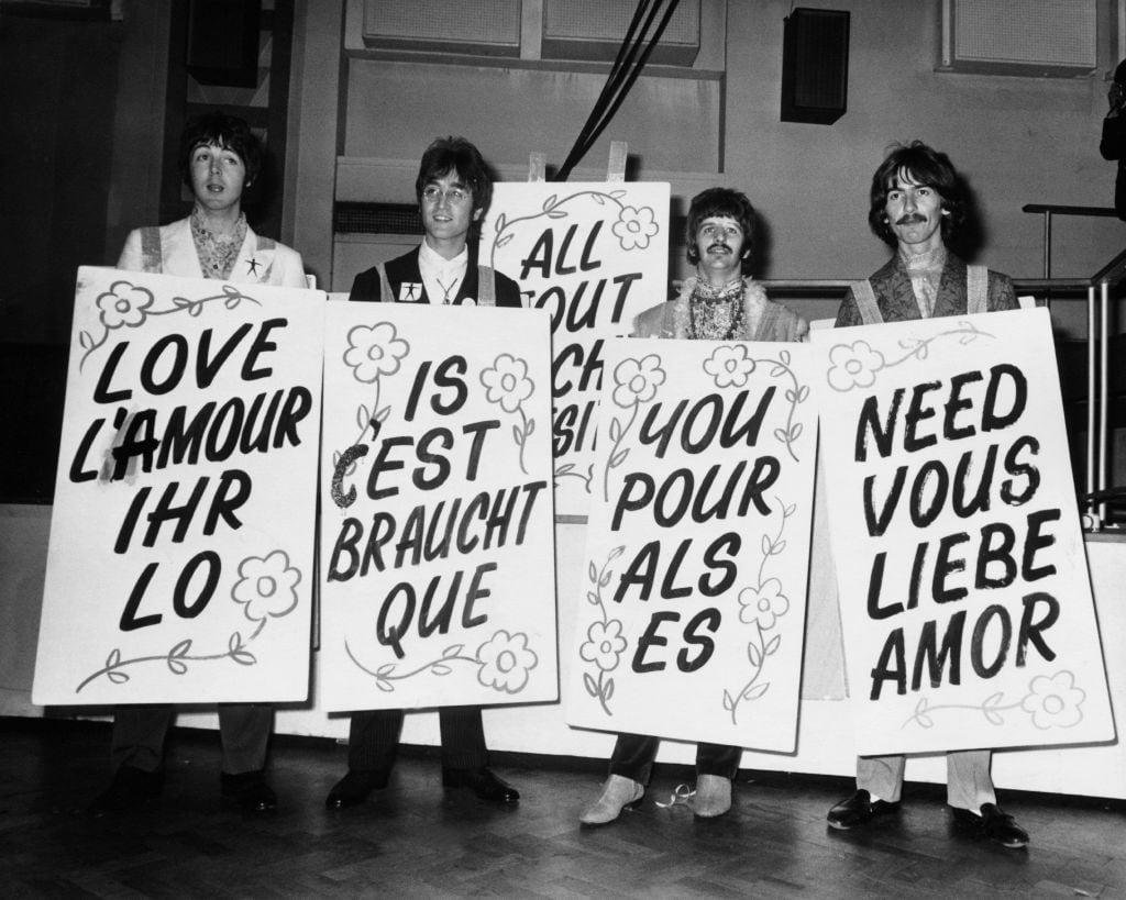 UNITED KINGDOM - JUNE 24:  During the recording of the program LIVE in Abbey Road E.M.I. studios, the four members of the BEATLES showing posters on which was written : LOVE IS ALL YOU NEED.  (Photo by Keystone-France/Gamma-Keystone via Getty Images)