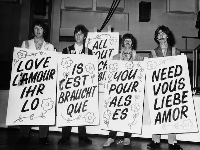 UNITED KINGDOM - JUNE 24: During the recording of the program LIVE in Abbey Road E.M.I. studios, the four members of the BEATLES showing posters on which was written : LOVE IS ALL YOU NEED. (Photo by Keystone-France/Gamma-Keystone via Getty Images)