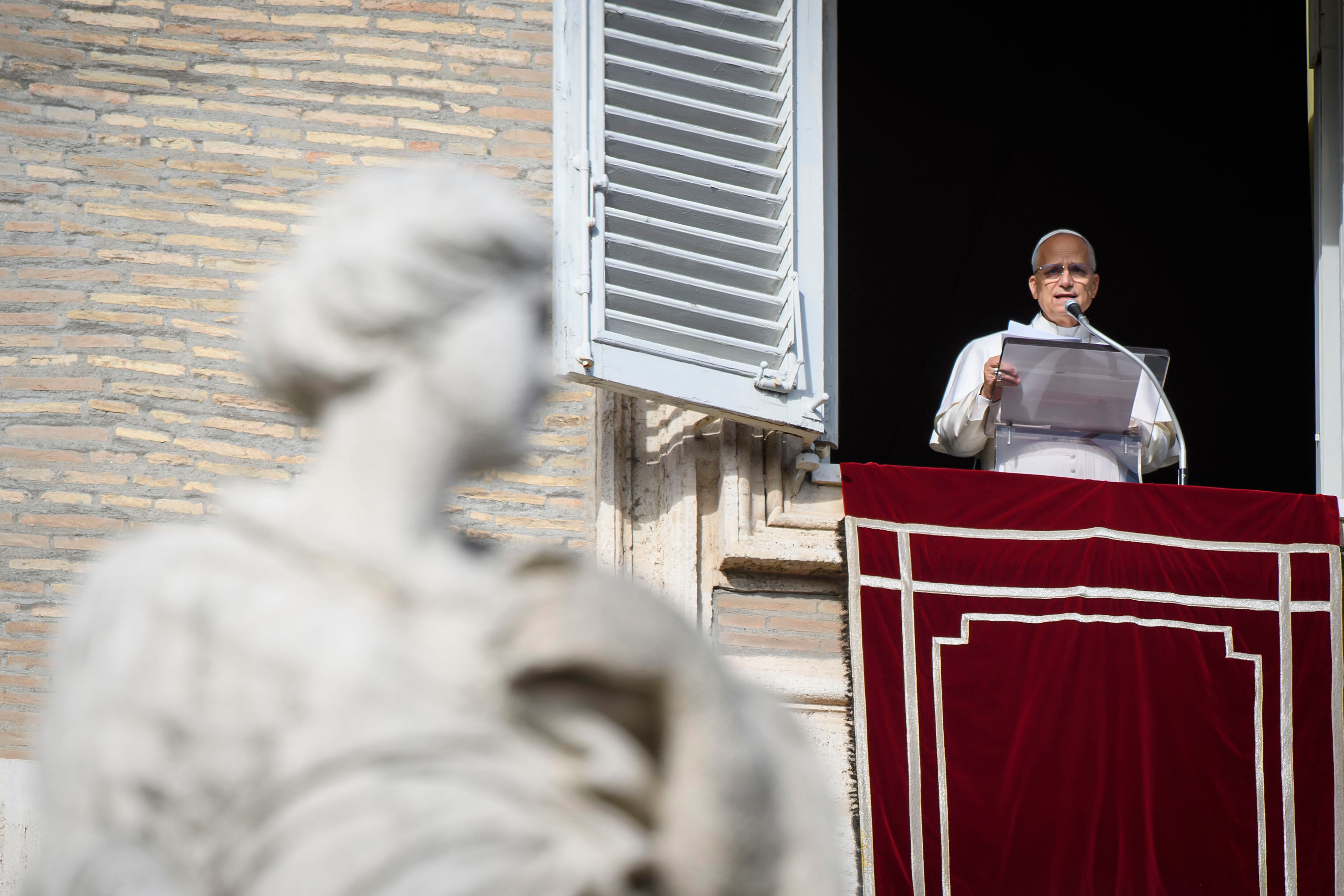 VATICAN CITY, VATICAN - DECEMBER 21:  (EDITOR NOTE: STRICTLY EDITORIAL USE ONLY - NO MERCHANDISING). Pope Leo XIV delivers his Sunday Angelus blessing from the window of his studio overlooking St. Peter's Square, on December 21, 2025 in Vatican City, Vatican. (Photo by Mario Tomassetti - Vatican Media via Vatican Pool/Getty Images)