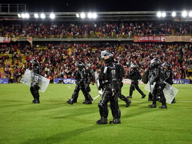 Agentes del UNDMO en medio de enfrentamientos de hinchas de Santa Fe y América de Cali en El Campín. Foto: (Colprensa - Cristian Bayona).