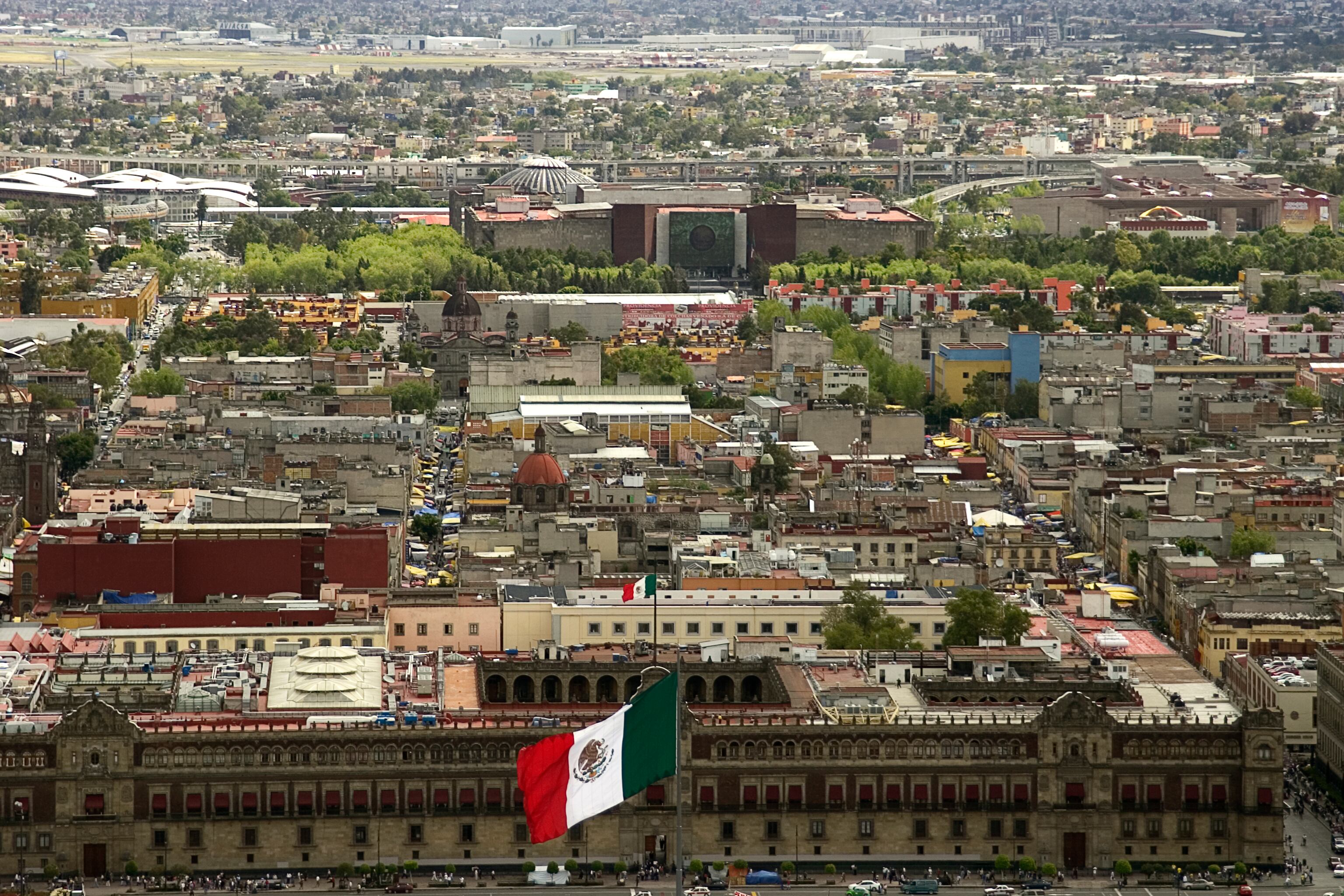 aerial view of mexico city, zocalo square and congress building in the background