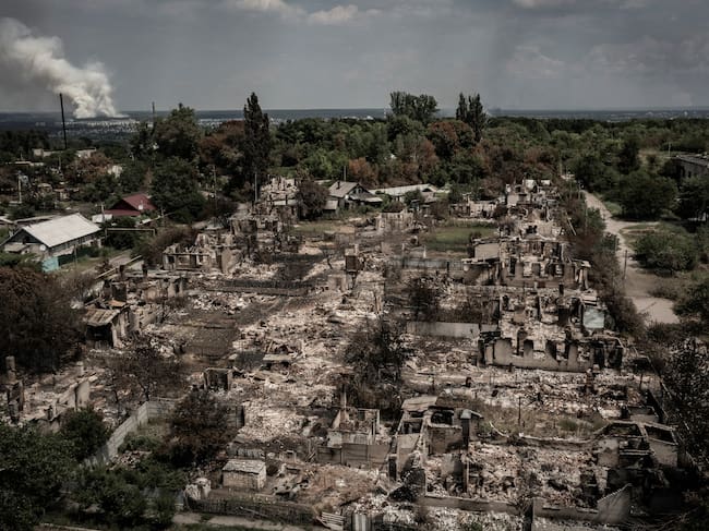 TOPSHOT - An aerial view shows destroyed houses after strike in the town of Pryvillya at the eastern Ukrainian region of Donbas on June 14, 2022, amid Russian invasion of Ukraine. - The cities of Severodonetsk and Lysychansk, which are separated by a river, have been targeted for weeks as the last areas still under Ukrainian control in the eastern Lugansk region. (Photo by ARIS MESSINIS / AFP) (Photo by ARIS MESSINIS/AFP via Getty Images)