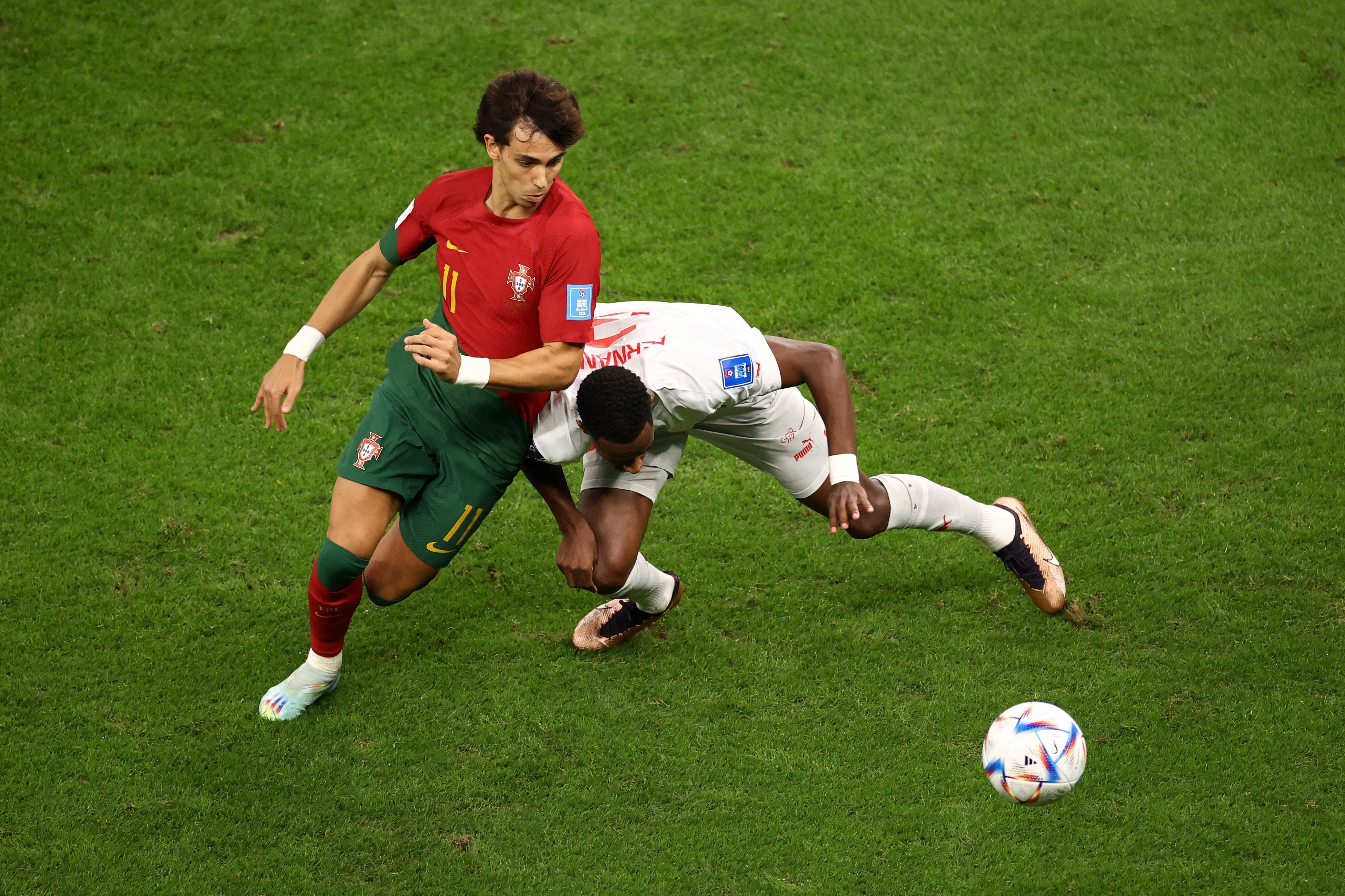 LUSAIL CITY, QATAR - DECEMBER 06: Joao Felix of Portugal battles for possession with Edimilson Fernandes of Switzerland during the FIFA World Cup Qatar 2022 Round of 16 match between Portugal and Switzerland at Lusail Stadium on December 06, 2022 in Lusail City, Qatar. (Photo by Robert Cianflone/Getty Images)