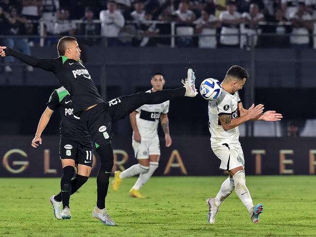 Atletico Nacional's midfielder Nelson Deossa (L) fights for the ball with Olimpia's forward Fernando Cardozo during the Copa Libertadores group stage second leg football match between Paraguay's Olimpia and Colombia's Atletico Nacional at the Defensores del Chaco stadium in Asuncion on June 8, 2023. (Photo by NORBERTO DUARTE / AFP) (Photo by NORBERTO DUARTE/AFP via Getty Images)