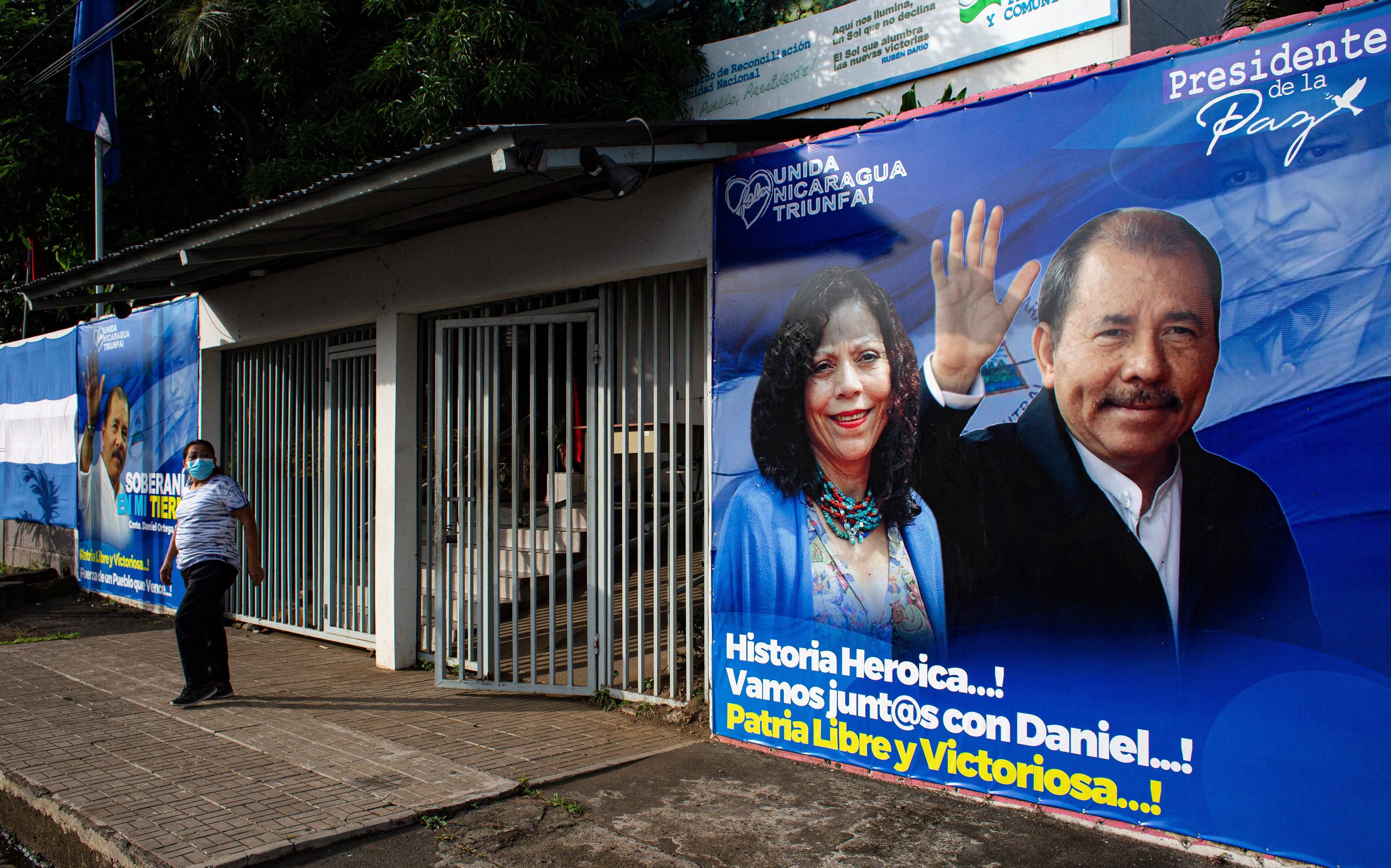 A man walks past a banner promoting Nicaragua's President Daniel Ortega and his wife and running mate Rosario Murillo candidacy, in Managua on September 24, 2021. - Nicaragua officially kicks off campaigning for the 7 November presidential elections on Saturday, with President Daniel Ortega's main rivals arrested and the way clear for him to seek a fourth consecutive term in office. (Photo by OSWALDO RIVAS / AFP) (Photo by OSWALDO RIVAS/AFP via Getty Images)