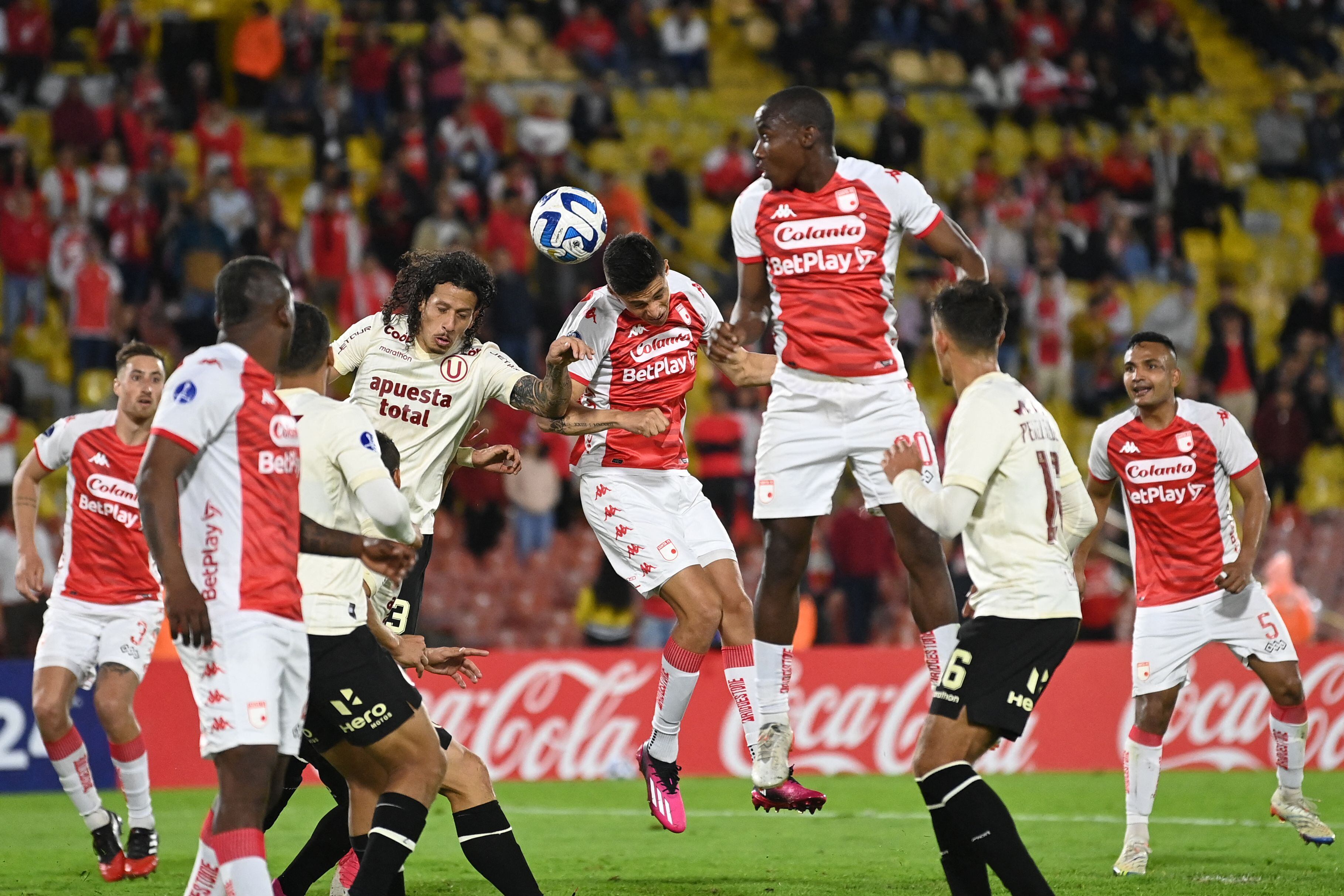 Universitario's Paraguayan defender Williams Riveros (L), Santa Fe's defender David Ramirez (C) and Santa Fe's defender Dairon Mosquera jump for the ball during the Copa Sudamericana group stage second leg football match between Colombia's Independiente Santa Fe and Peru's Universitario at the Nemesio Camacho "El Campin" stadium in Bogota on June 8, 2023. (Photo by JUAN BARRETO / AFP) (Photo by JUAN BARRETO/AFP via Getty Images)