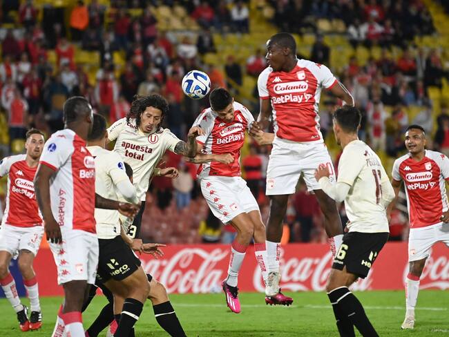 Universitario's Paraguayan defender Williams Riveros (L), Santa Fe's defender David Ramirez (C) and Santa Fe's defender Dairon Mosquera jump for the ball during the Copa Sudamericana group stage second leg football match between Colombia's Independiente Santa Fe and Peru's Universitario at the Nemesio Camacho "El Campin" stadium in Bogota on June 8, 2023. (Photo by JUAN BARRETO / AFP) (Photo by JUAN BARRETO/AFP via Getty Images)