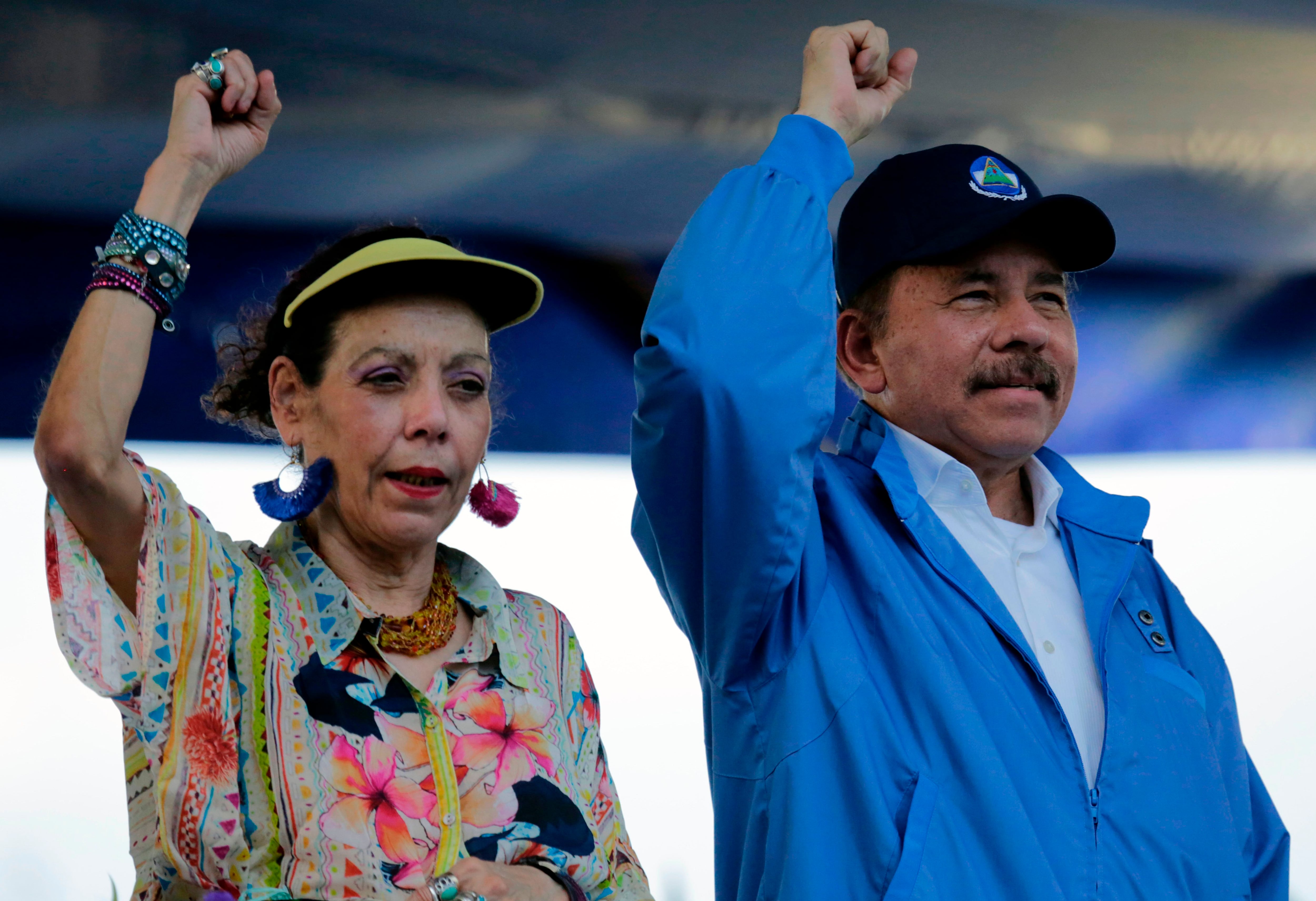 Nicaraguan President Daniel Ortega and his wife, Vice-President Rosario Murillo, raise their fists during the commemoration of the 51st anniversary of the Pancasan guerrilla campaign in Managua, on August 29, 2018. - Ortega called the UN High Commissioner for Human Rights "infamous" and "terror instrument", after it denounced Wednesday systematic human rights violations in the framework of opposition protests in which 300 people were killed. (Photo by INTI OCON / AFP)        (Photo credit should read INTI OCON/AFP via Getty Images)