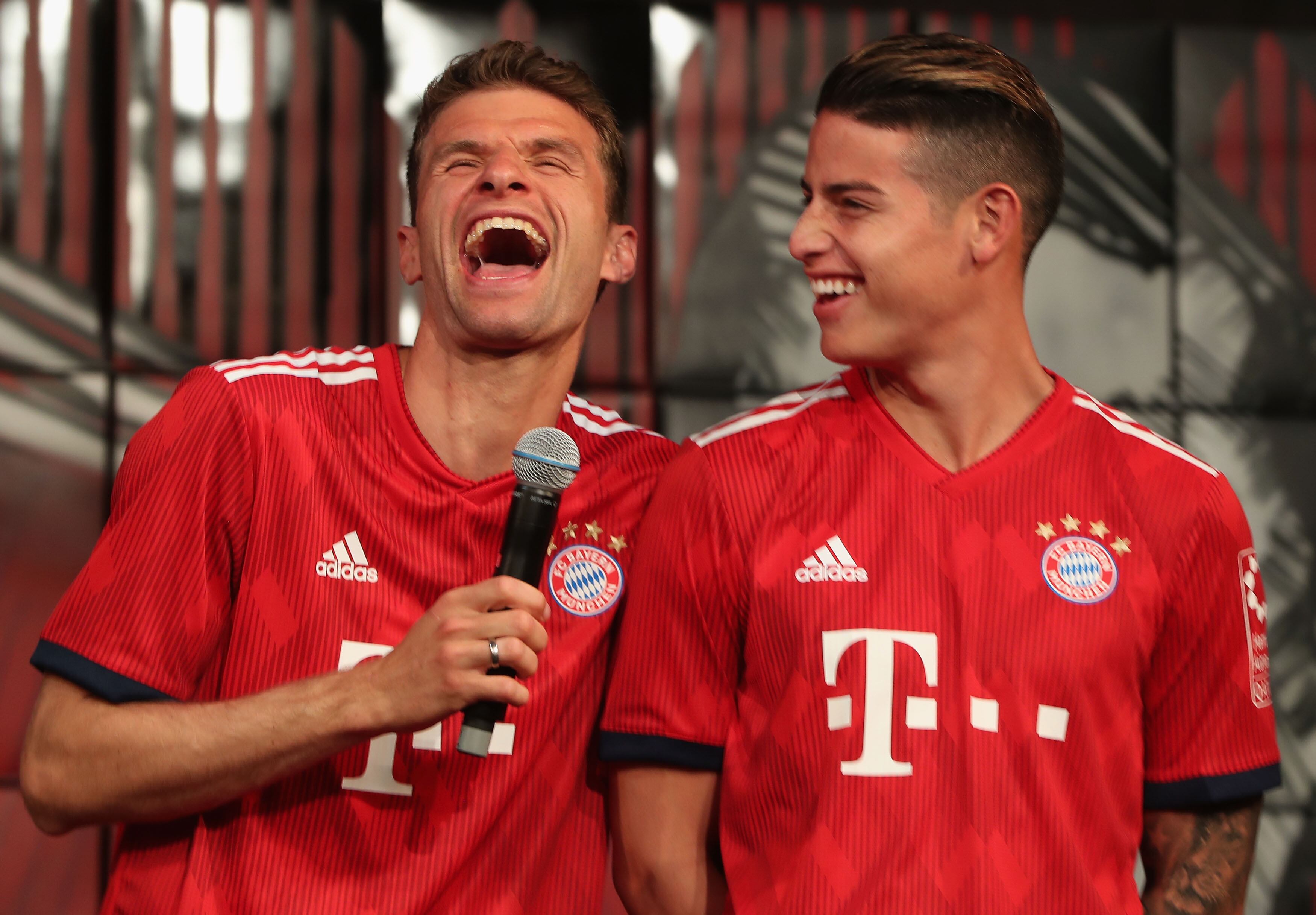 MUNICH, GERMANY - MAY 08: Thomas Mueller (L) and James Rodriguezof FC Bayern Muenchen joke wearing their new unveiled Adidas home jersey for the upcoming Bundesliga season 2018/19 during the official presentation on May 8, 2018 in Munich, Germany. (Photo by Alexandra Beier/Bongarts/Getty Images)