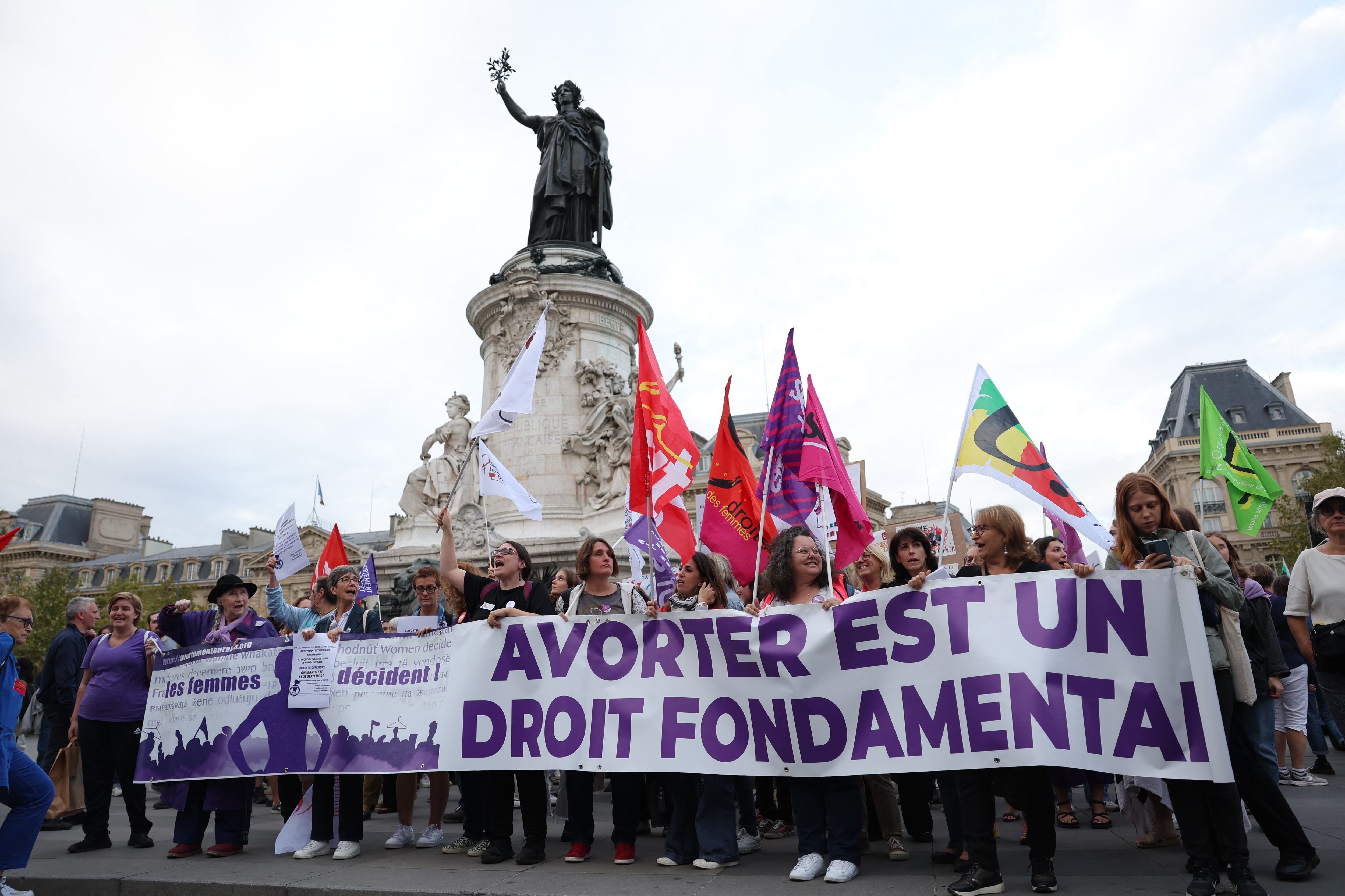 Women hold a banner reading "Abortion is a fundamental right" during a rally to support women's right to abortion on the occasion of the International Safe Abortion Day in Paris, on September 28, 2023. (Photo by Thomas SAMSON / AFP)