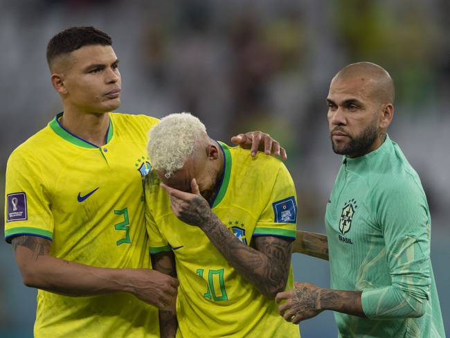 AL RAYYAN, QATAR - DECEMBER 09: Neymar of Brazil is consoled by team mates Thiago Silva and Dani Alves during the FIFA World Cup Qatar 2022 quarter final match between Croatia and Brazil at Education City Stadium on December 9, 2022 in Al Rayyan, Qatar. (Photo by Visionhaus/Getty Images)