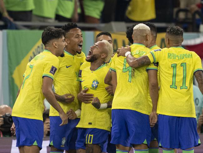 DOHA, QATAR - DECEMBER 05: Brazil players celebrate the penalty scored by Neymar to make the score 2-0 during the FIFA World Cup Qatar 2022 Round of 16 match between Brazil and South Korea at Stadium 974 on December 5, 2022 in Doha, Qatar. (Photo by Sebastian Frej/MB Media/Getty Images)
